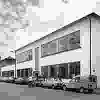 Office building exterior with parked vehicles